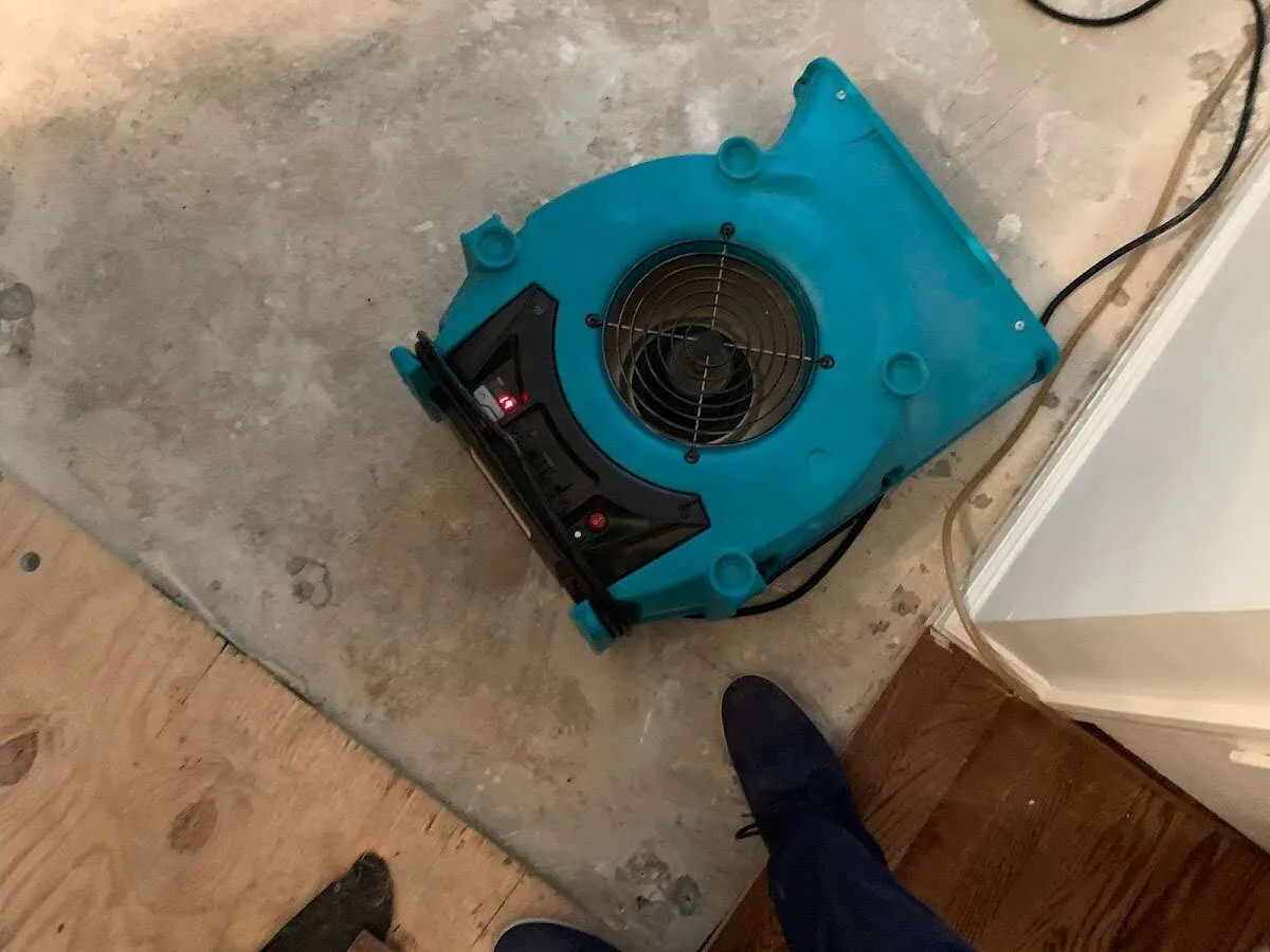 Air mover drying subfloor during Leak Detection & Repair in Englewood